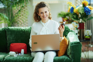 happy woman buying pharma in modern living room in sunny day